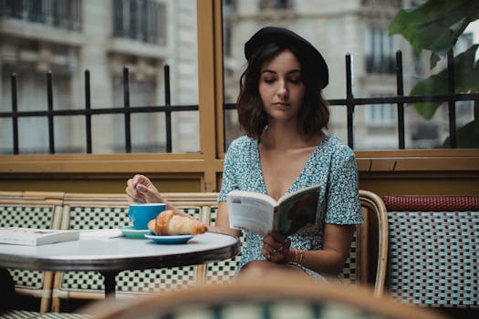 pexels-photo-5177507-5177507 A woman enjoys a book with coffee at a Parisian cafe, exuding a calm and classic ambiance.