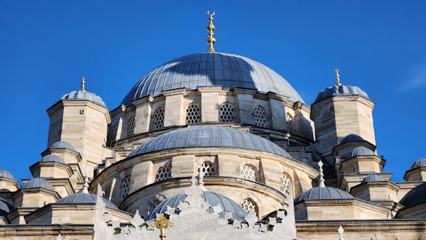 pexels-photo-28905274-28905274 Close-up of the New Mosque's intricate domes in Istanbul under a clear blue sky.
